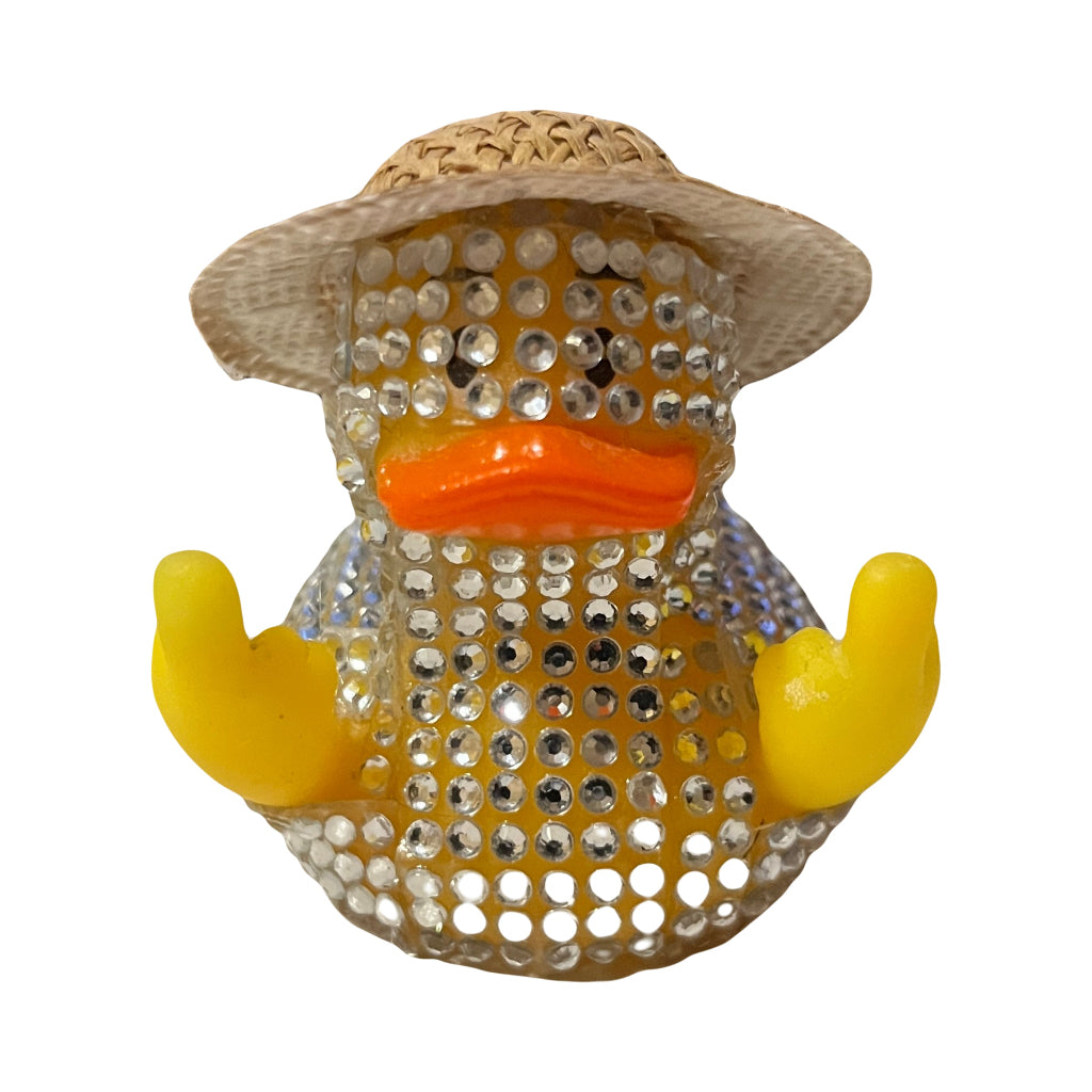 Diamante Duck Figurine - A yellow rubber duck adorned with clear rhinestones, wearing a woven straw hat and an orange beak, with middle fingers pointing upwards, shown against a plain white background.