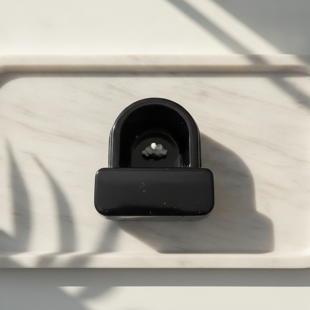 Novelty Toilet Ornaments - A miniature black resin toilet figurine with a small white finger pointing upwards in the pan on a ceramic tray