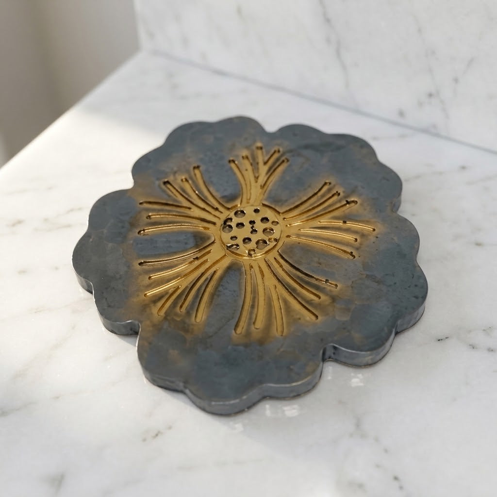 Scalloped Floral Coasters - A scalloped grey and gold coaster with a sunburst centre, shown on a white marble surface.