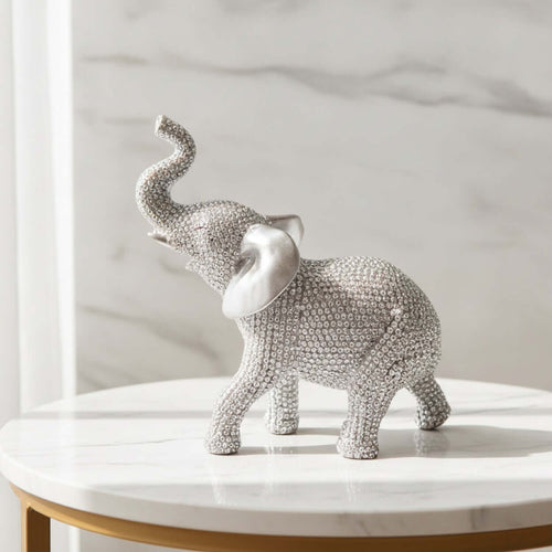 Beaded Elephant Figurine in a standing pose on a marble table, showcasing detailed beading and a raised trunk.