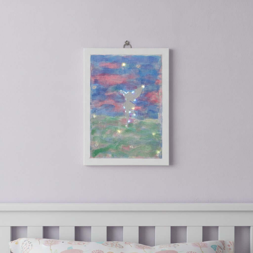 LED Fairy Picture - An unframed pastel art canvas featuring a silver fairy and glowing led light stars, displayed on a light lavender wall above a white wooden crib.